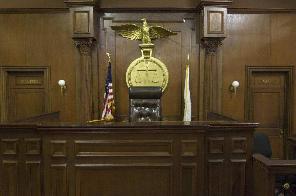 Legal scales behind judges chair in court